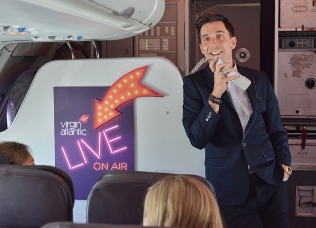 Russell Kane performs his highest ever gig on board Virgin Atlantic Little Red as passengers kick off Edinburgh Festival Fringe in the sky!