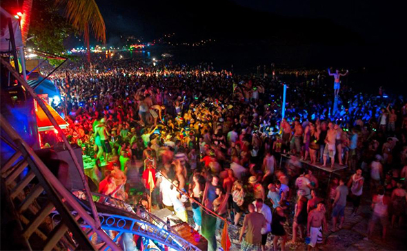 Tourists in Thailand partying the night away at a full moon party