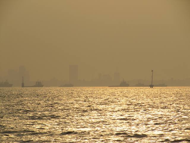 Smog casts a scorched earth light over Mumbai Harbour.