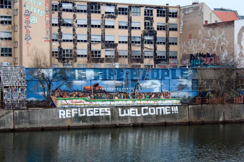 Across the river a sign of welcome to the Syrian refugees that are arriving in the city.
