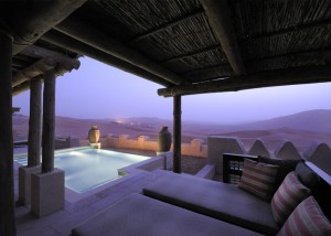 pool and deck chair in desert