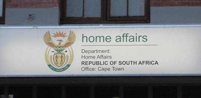 You can apply for a Temporary SA Passport at the Home Affairs Office in Cape Town.