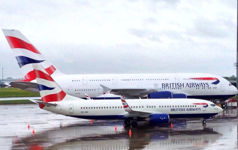 The A380 dwarfs a smaller BA aircraft.
