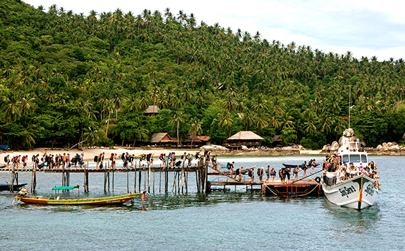 Tourists boarding a ferry to a full moon party in Khao Tao island, Thailand