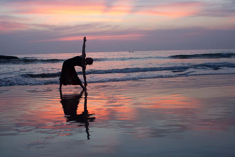 Doing Yoga on the beach in Goa, India.