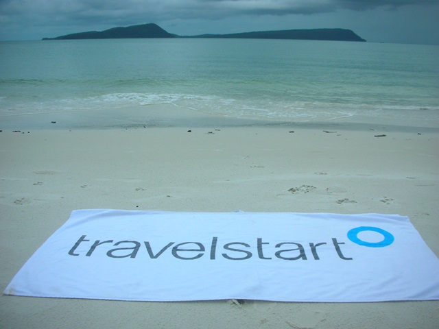 Travelstart branded towel on Cambodian beach.