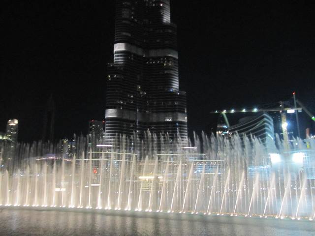 The Dubai Fountain at night with Burj Khalifa in the background.