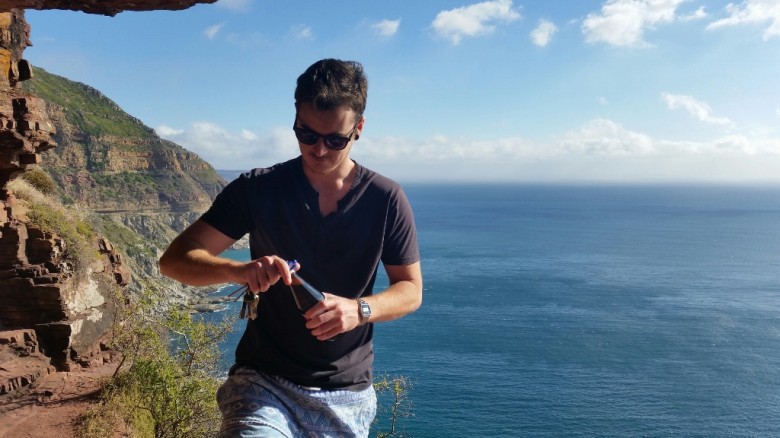 Opening a beer and enjoying the view from the Cave under Chapman's Peak Drive