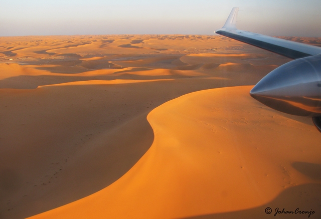 Final approach into an oil field in southern Algeria. Flying low over the dunes of the Sahara Desert.
