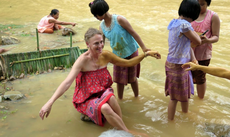 Enjoying the white mud health treatment in the river.