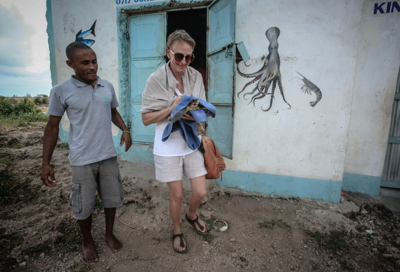 With Fikiri picking up a turtle from a fishing village. Photo by Linda Markovina.