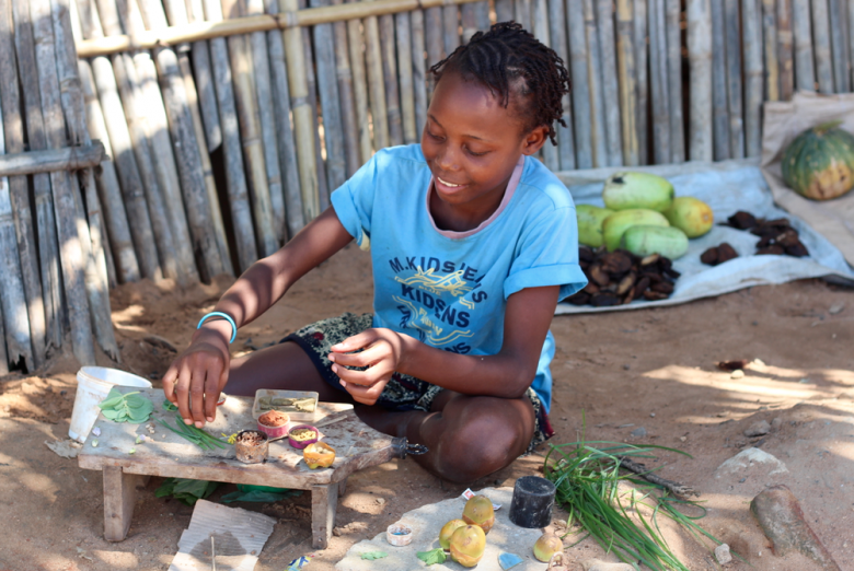 A little girl trading in fresh produce on the streets of Pemba.
