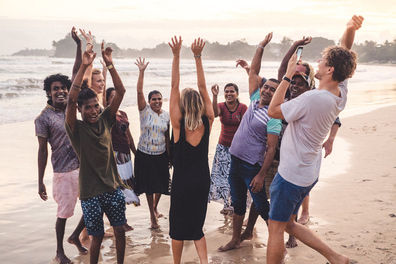 students dancing on beach