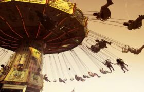 People enjoying a swing ride at a festive amusement park in Johannesburg during December 2025, capturing the fun and adrenaline of things to do in Johannesburg during the summer holiday season.