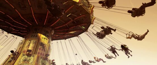 People enjoying a swing ride at a festive amusement park in Johannesburg during December 2025, capturing the fun and adrenaline of things to do in Johannesburg during the summer holiday season.