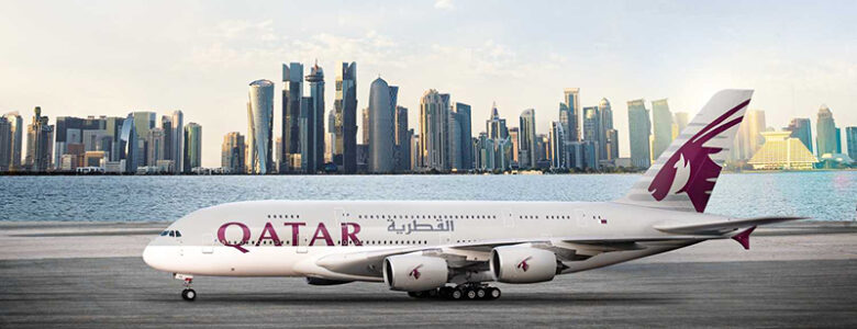 A Qatar Airways plane on a runway with the Doha Skyline in the background. These are the top holiday destinations for South Africans in 2025