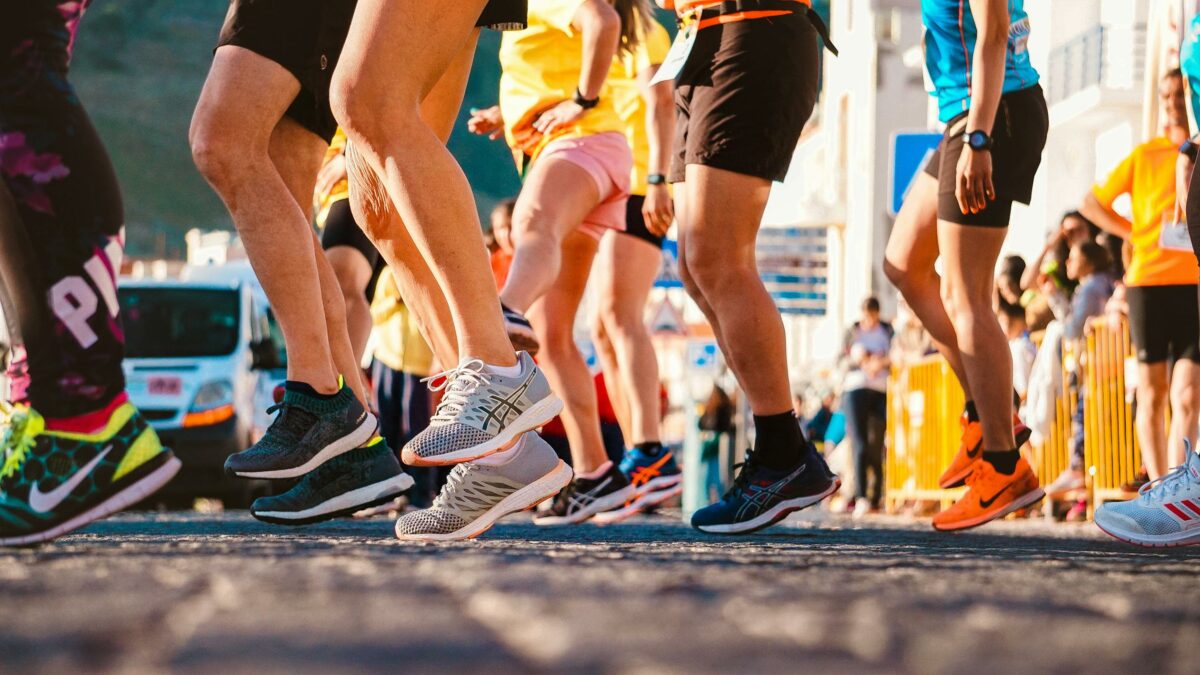 A crowd of people running through a city