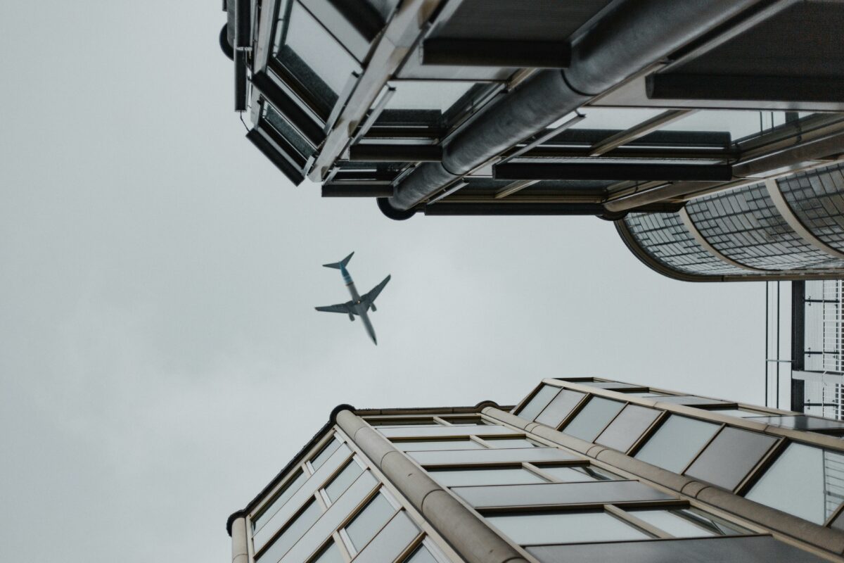 Airplane flying in between two buildings