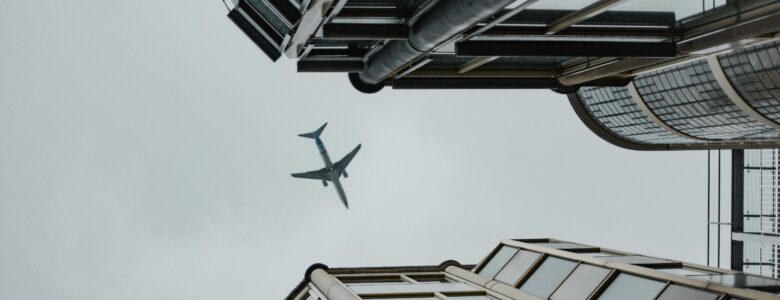 Airplane flying in between two buildings