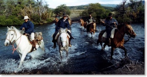 Argentina Horse Ride Riders on horseback crossing a river in argentina