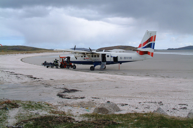 Barra Airport Plane landed at Barra Airport unloading baggage on beach