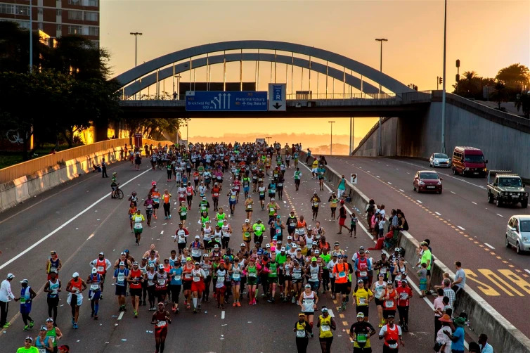 A crowd on marathon runners along Durban's highways during the Comrades Marathon. Here are things to do in Durban during the Comrades marathon 2025