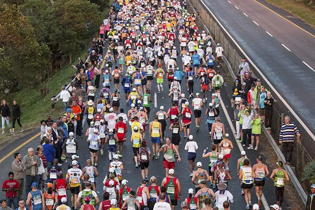 A crowd on marathon runners along Durban's highways during the Comrades Marathon. Here are things to do in Durban during the Comrades marathon 2025