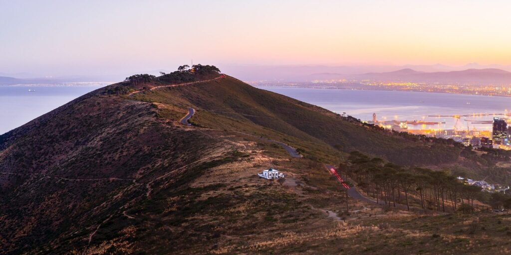 Signal Hill at sunset. Showing Signal road winding up to the top. This is the one of the free things to do in Cape Town this weekend