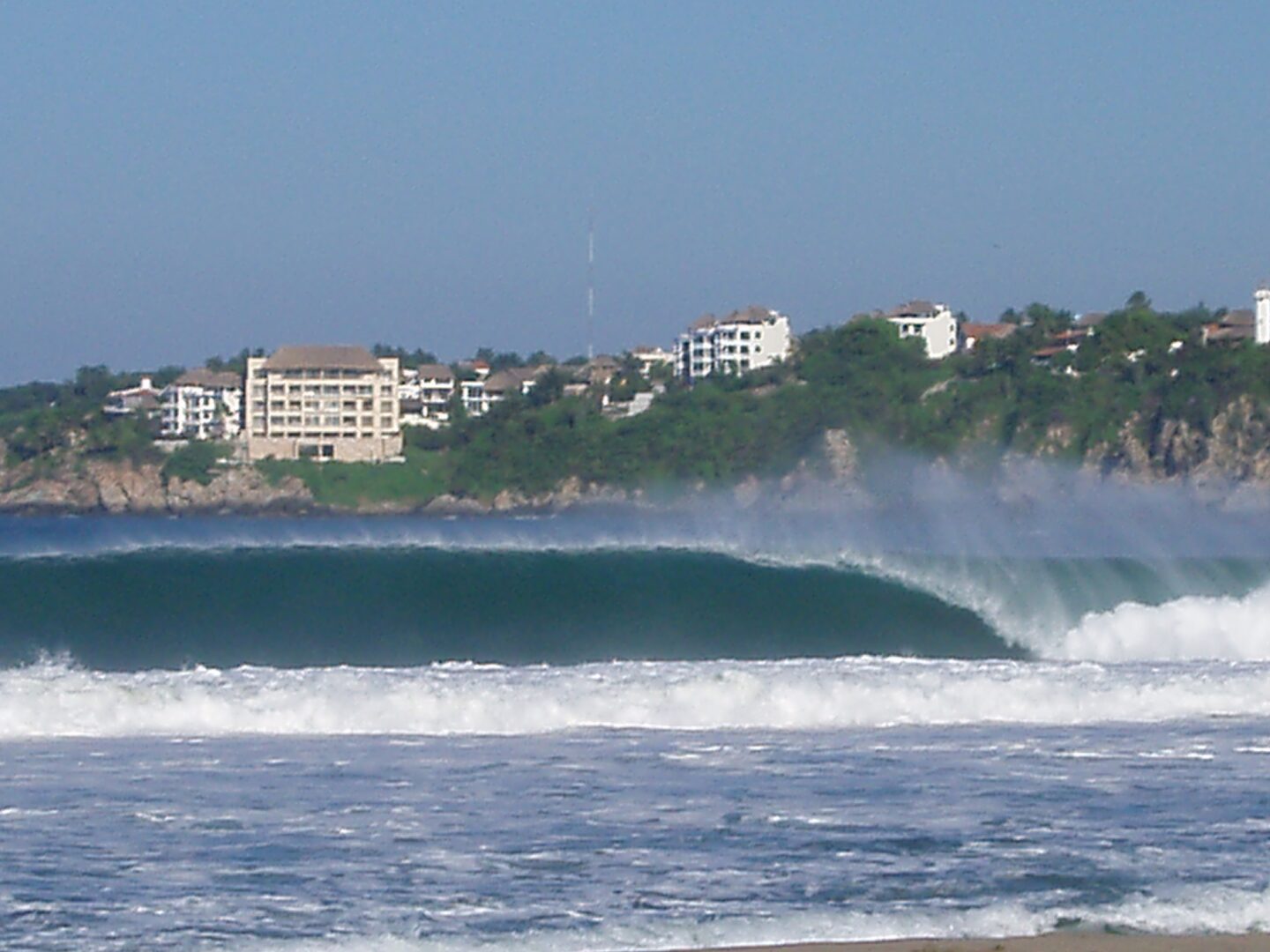 A wave breaks across the bay at Puerto Escondido.