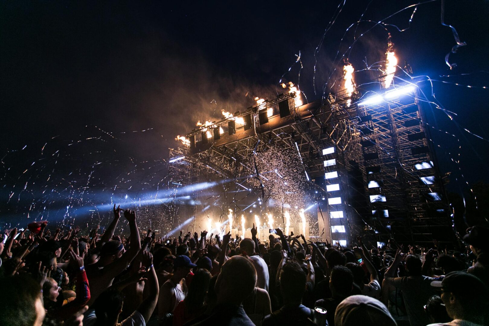 Crowds haveing fun in front of a big EDM music stage at the Roskilde Music Festival in Europe