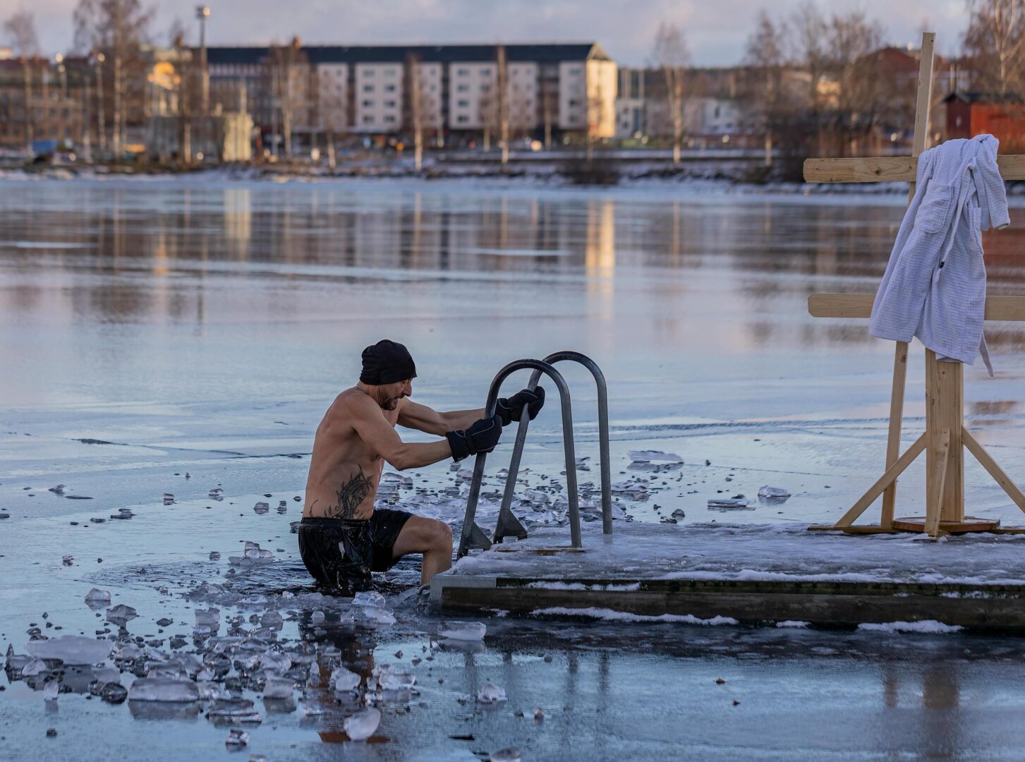 Man taking a cold plunge in an icy lake in Scandinavia. A normal morning routine in that part of the world