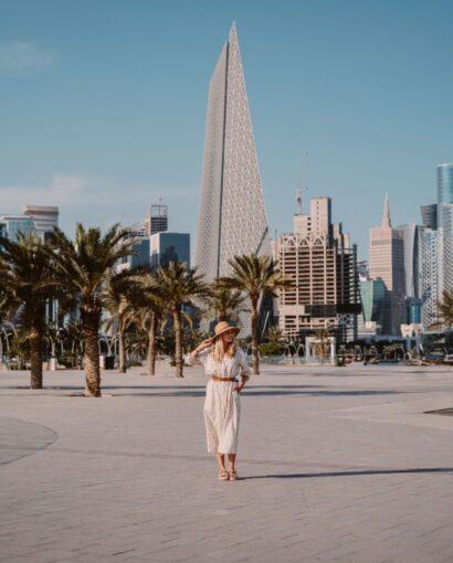 Woman standing in front of the Doha Skyline. Travel to Qatar