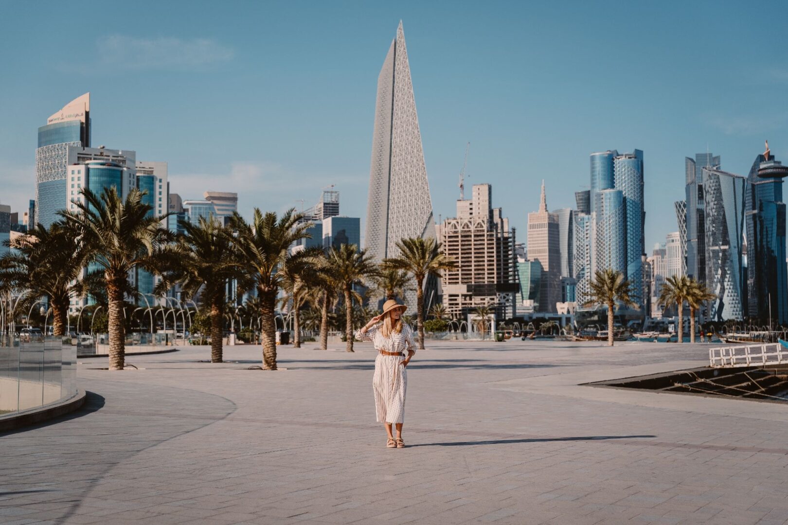 Woman standing in front of the Doha Skyline. Travel to Qatar