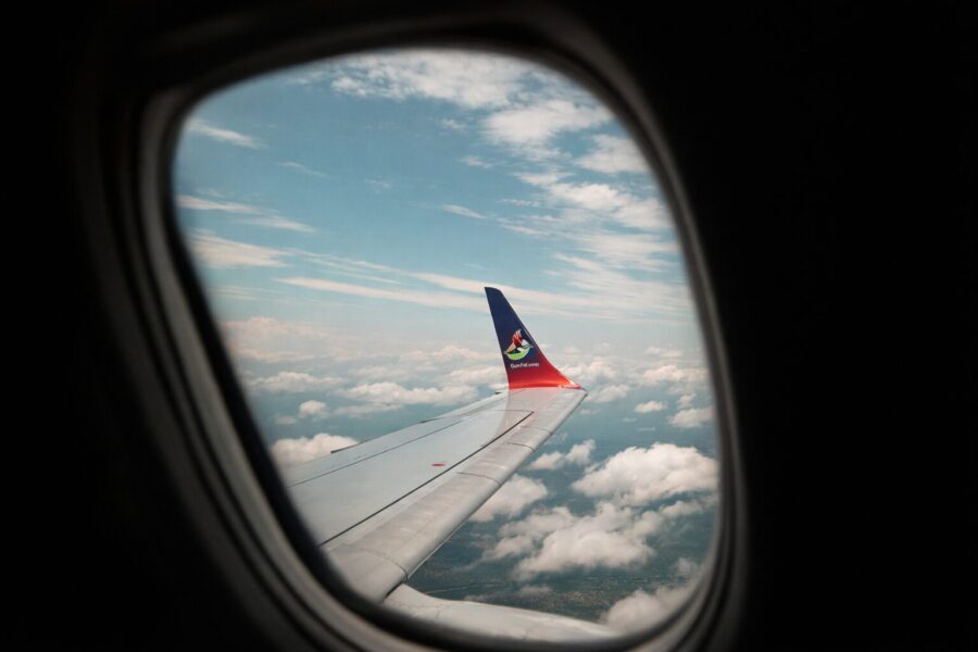Airlink plane wing in the sky. A business flight booked on Travelstart+