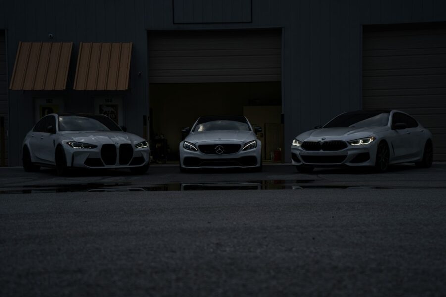3 BMW cars photographed in dim lighting. This is for the cheapest car hire in South Africa and abroad.