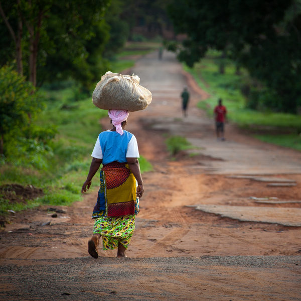 Liberia woman walking bag on head